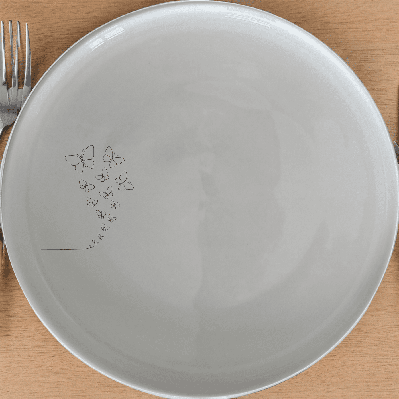 Delicate Butterflies Side Plate Set of 4 - Range 4 is a stunning collection of four white ceramic side plates featuring an intricate laser-etched design of delicate butterflies. Perfect for adding a touch of elegance to any dining table.