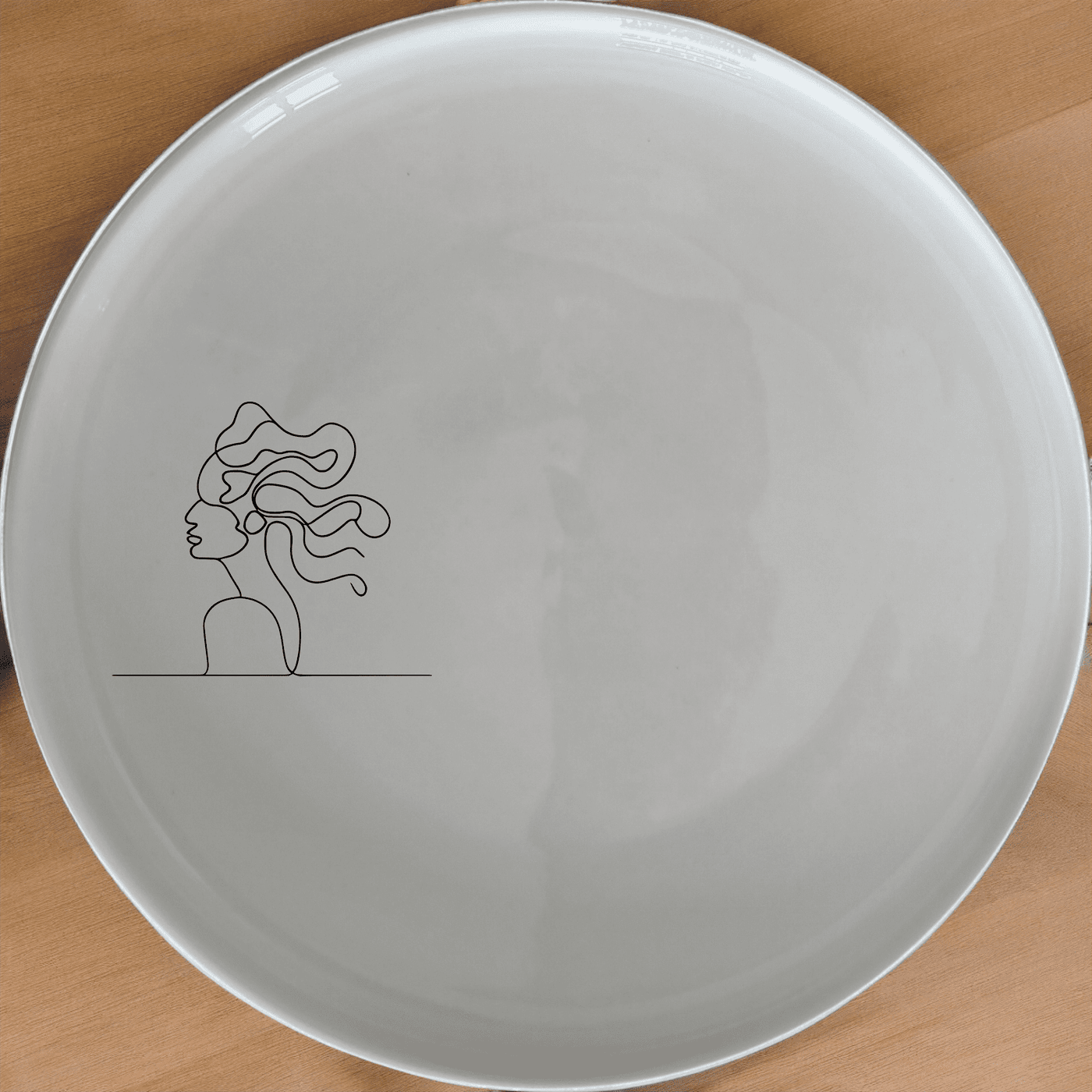 The Woman Faces Hair Dinner Plate Set of 4 features a minimalist design with an abstract silhouette, perfect for modern dining settings.