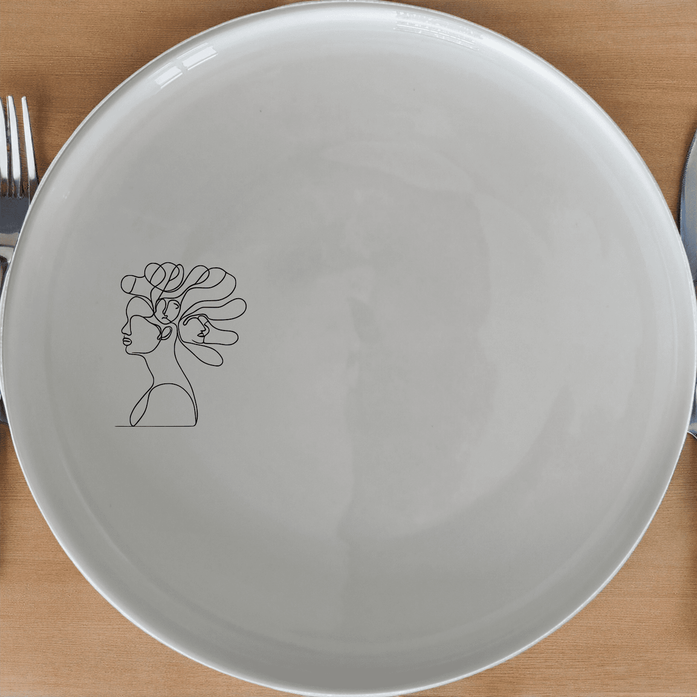 The Woman Faces Hair Side Plate Set of 4 features a minimalist design with abstract faces in hair, perfect for modern dining.
