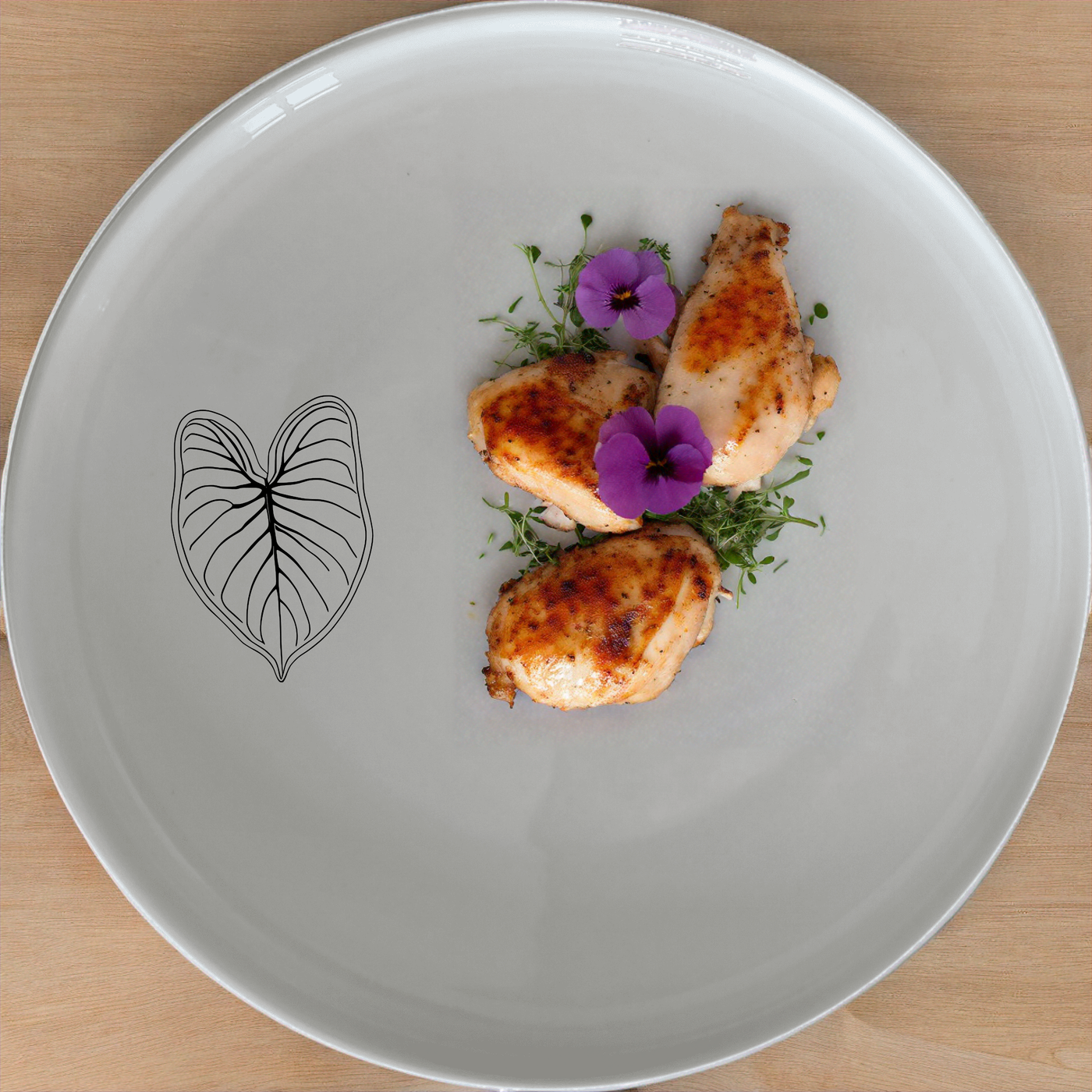 The Caladium Bicolor Dinnerware Set of 12 - Range 1 brings a touch of nature to your dining table with its elegant leaf design.