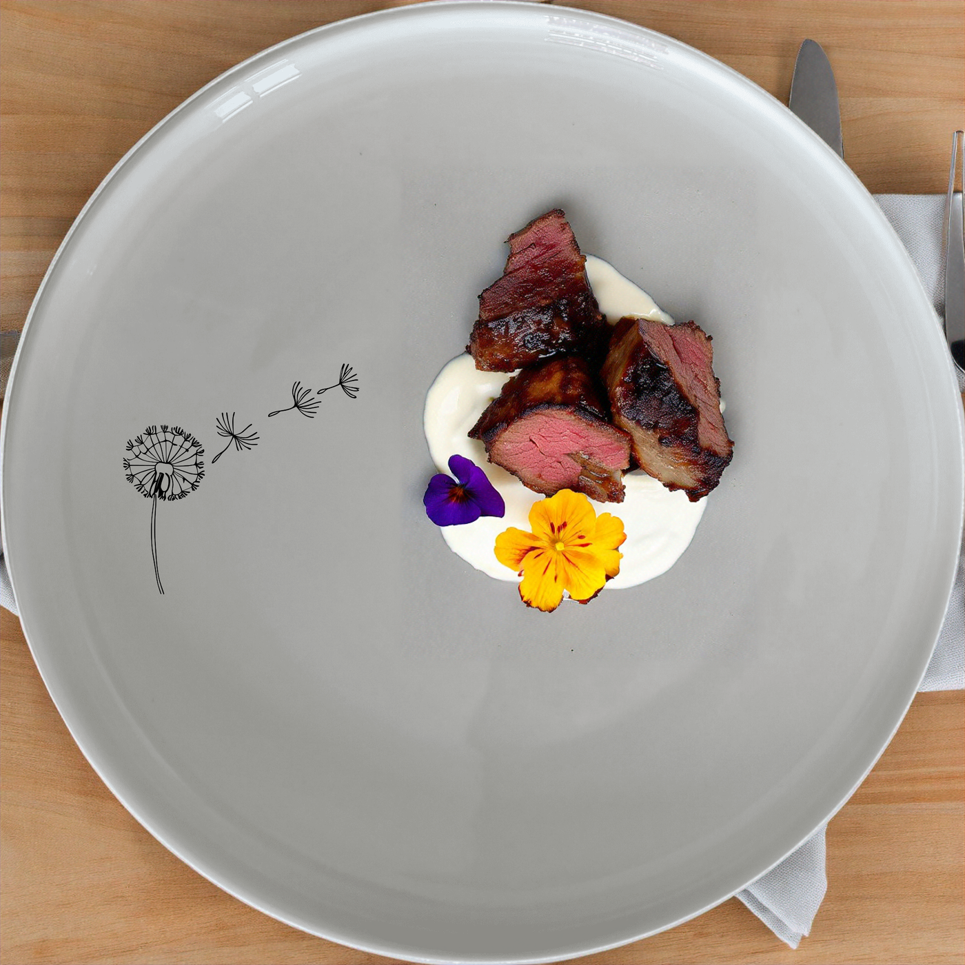 The Dandelion Seeds Wind Dinnerware Set of 12 - Range 2 brings a touch of nature to your dining table with delicate dandelion designs.