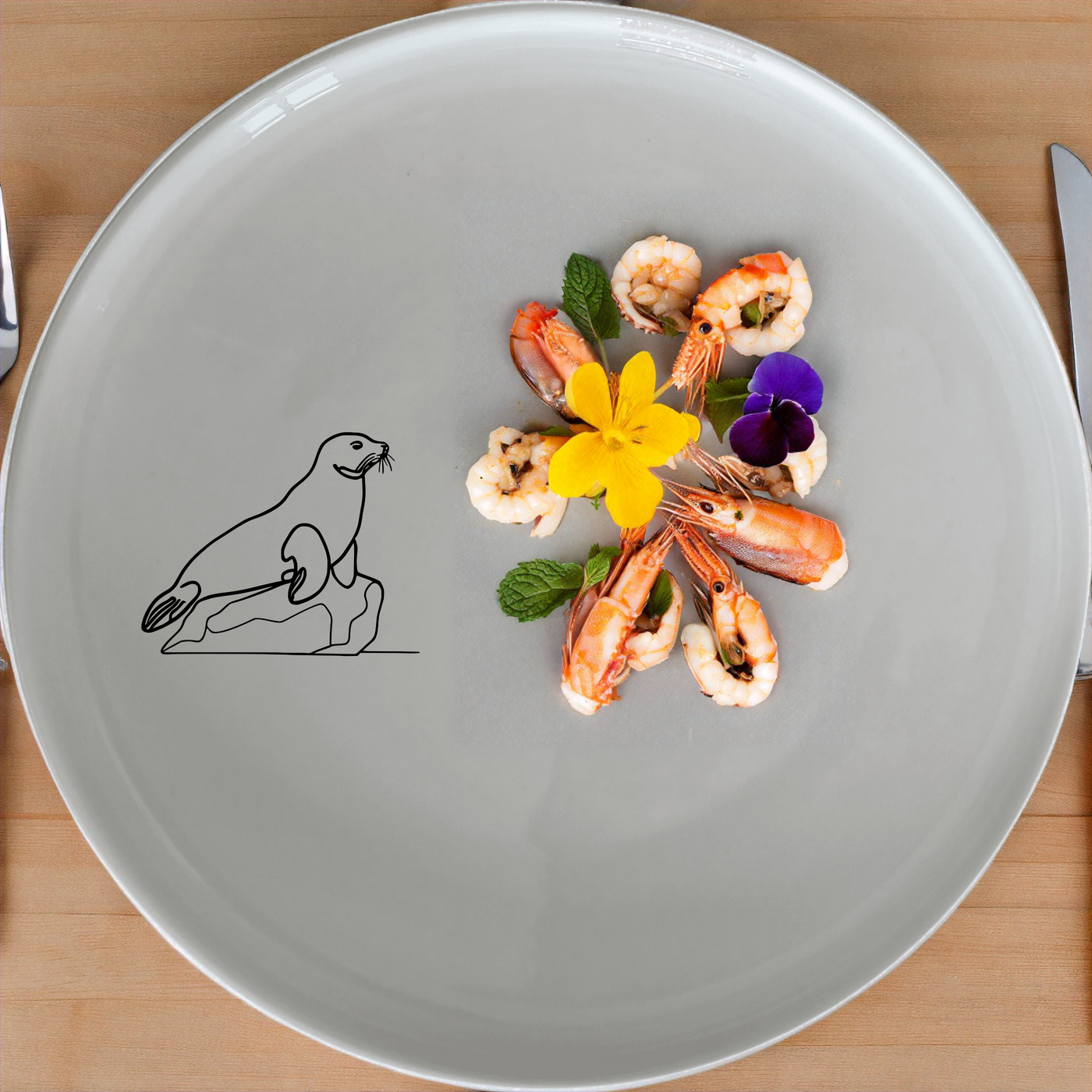 The Harbor Seal Rock Dinnerware Set of 12 - Range 1 features unique ceramic plates with a charming harbor seal design, perfect for everyday meals and special occasions.