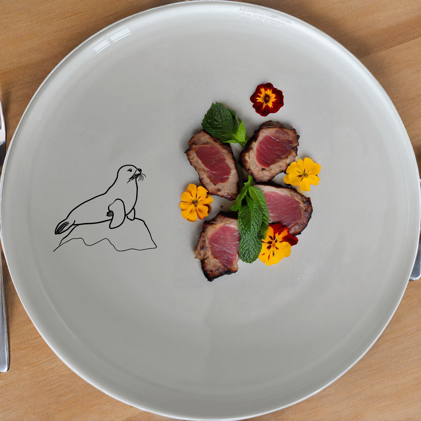 The Harbor Seal Rock Dinnerware Set of 12 - Range 2 features a charming design perfect for any dining occasion.