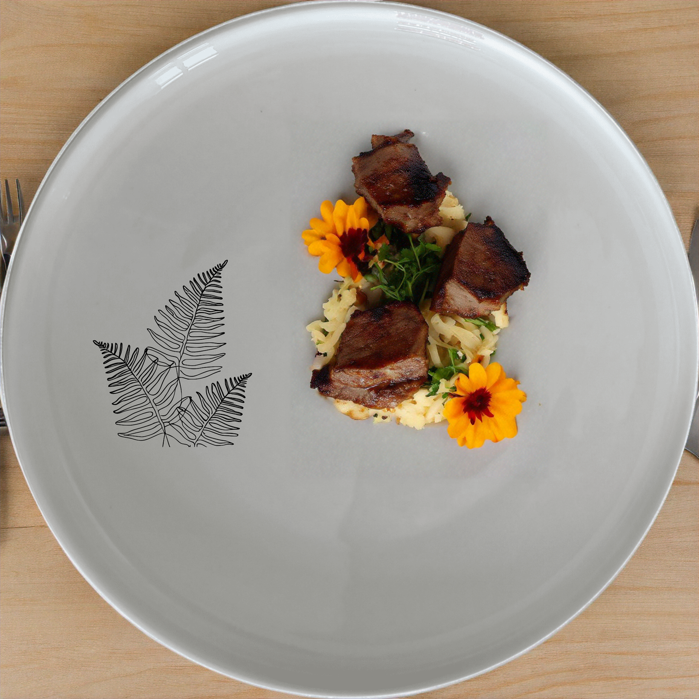 The Layered Fern Fronds Dinnerware Set of 12 - Range 1 combines modern design with nature-inspired elegance, perfect for everyday meals and special occasions.
