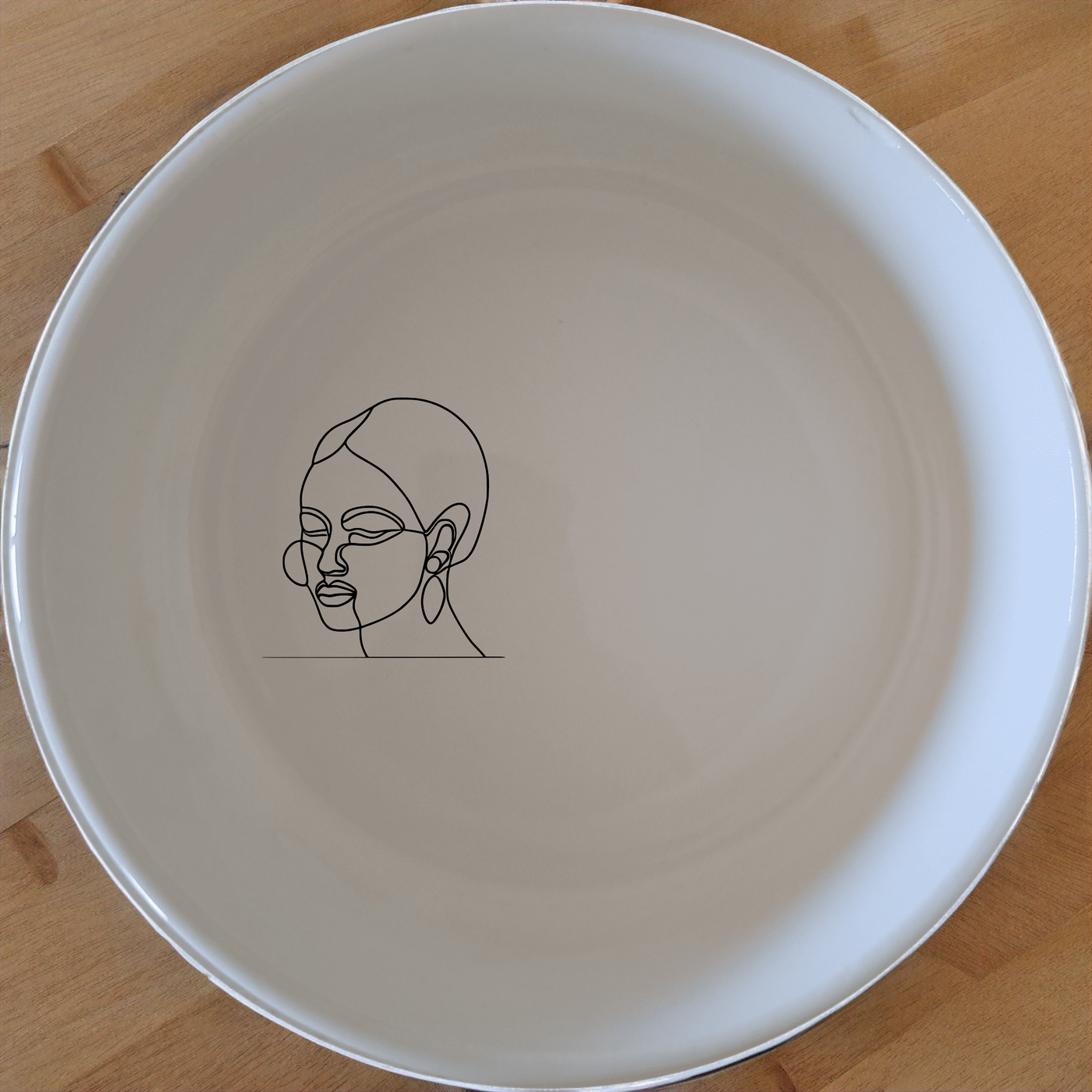 Face of Maasi Young Woman Bowl Set of 4 - Range 1 is a stunning and modern addition to any kitchen. This set features four beautifully designed bowls with a unique and artistic touch. Perfect for everyday use or special occasions, these bowls are sure to elevate your dining experience.