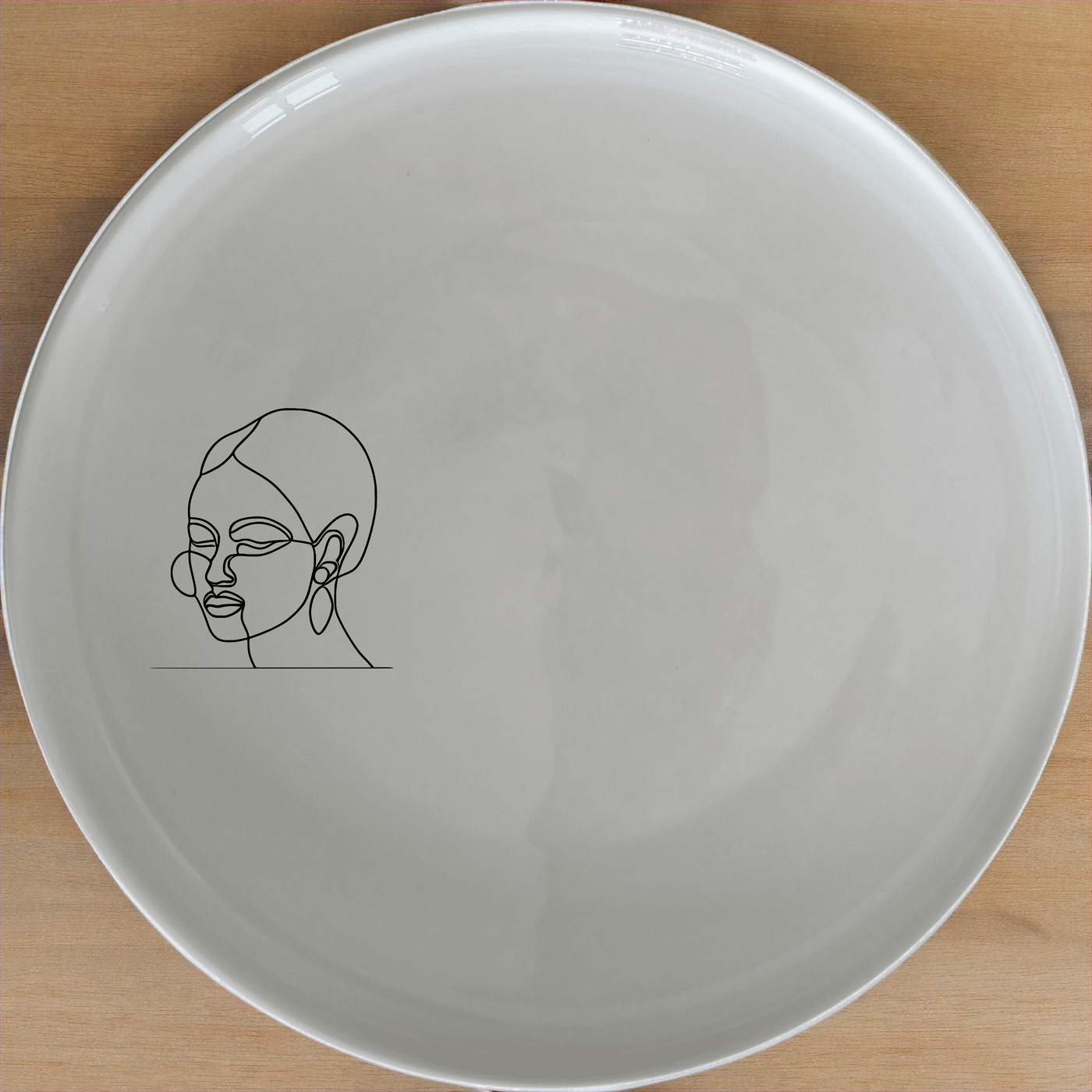 Face Of Maasi Dinner Plate Set of 4 - Range 1 features a striking silhouette design, perfect for modern dining. Crafted from premium ceramic, these plates are both dishwasher and microwave safe, offering durability and convenience for everyday use.