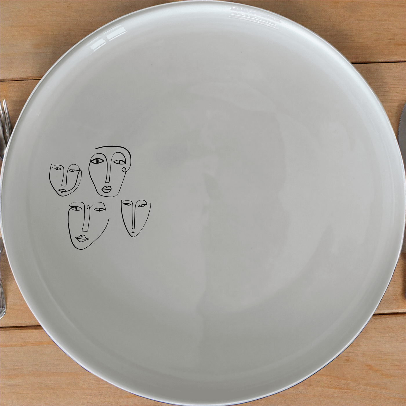 The Four Faces Dinner Plate Set of 4 - Range 1 features abstract face designs on white ceramic plates, perfect for modern dining settings.