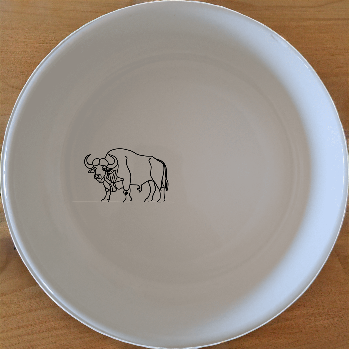 Buffalo Herd Bowl Set of 4 - Range 2 is a stunning collection of four ceramic bowls featuring a powerful buffalo design. Perfect for everyday use or special occasions.