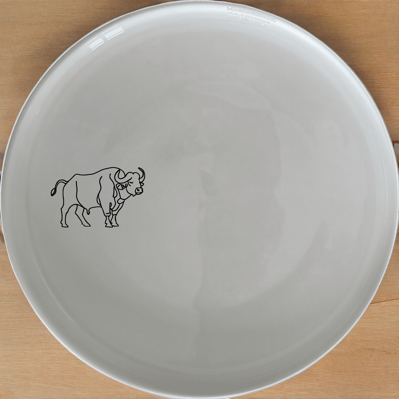 Buffalo Herd Dinner Plate Set of 4 - Range 3 offers a bold and striking design perfect for modern dining. This set of four dinner plates features a powerful buffalo illustration, adding a touch of nature to your table setting. Ideal for both everyday use and special occasions, these plates are crafted from durable ceramic and are microwave and dishwasher safe.