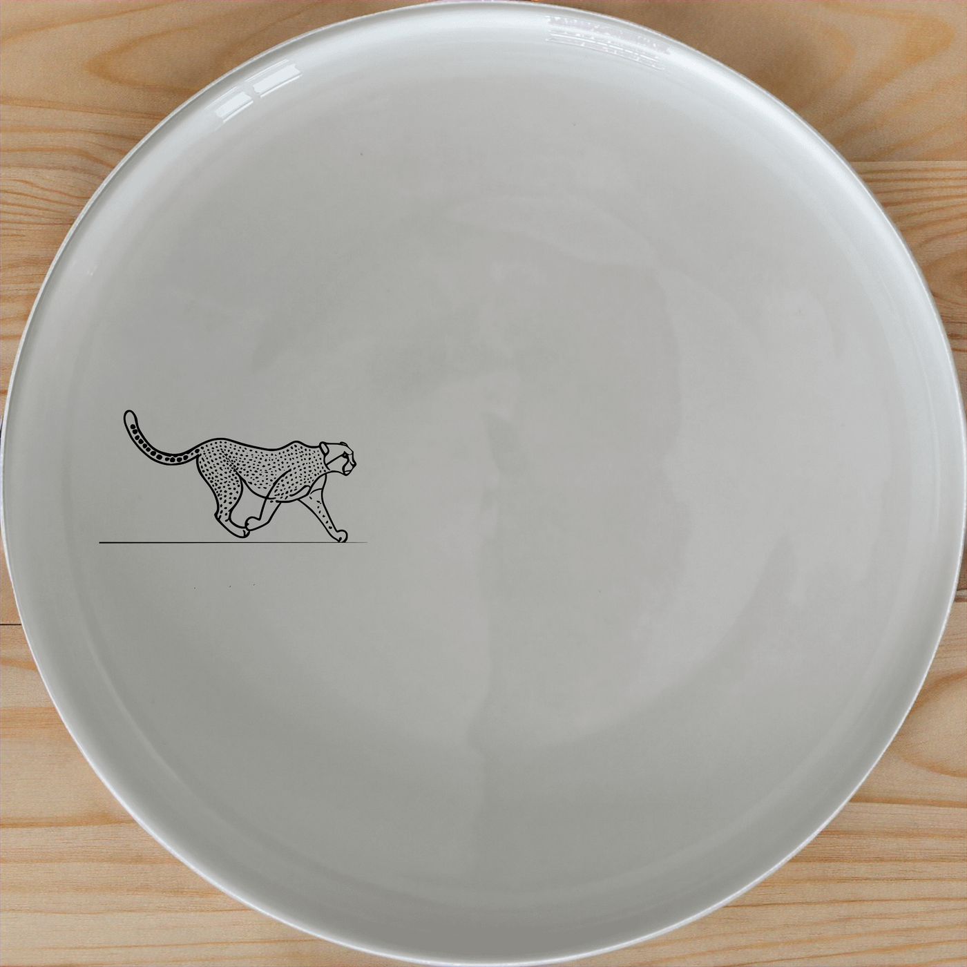 The Graceful Cheetah Dinner Plate Set of 4 - Range 1 features sleek cheetah artwork, perfect for modern dining. Each plate is crafted from durable ceramic and is dishwasher and microwave safe.