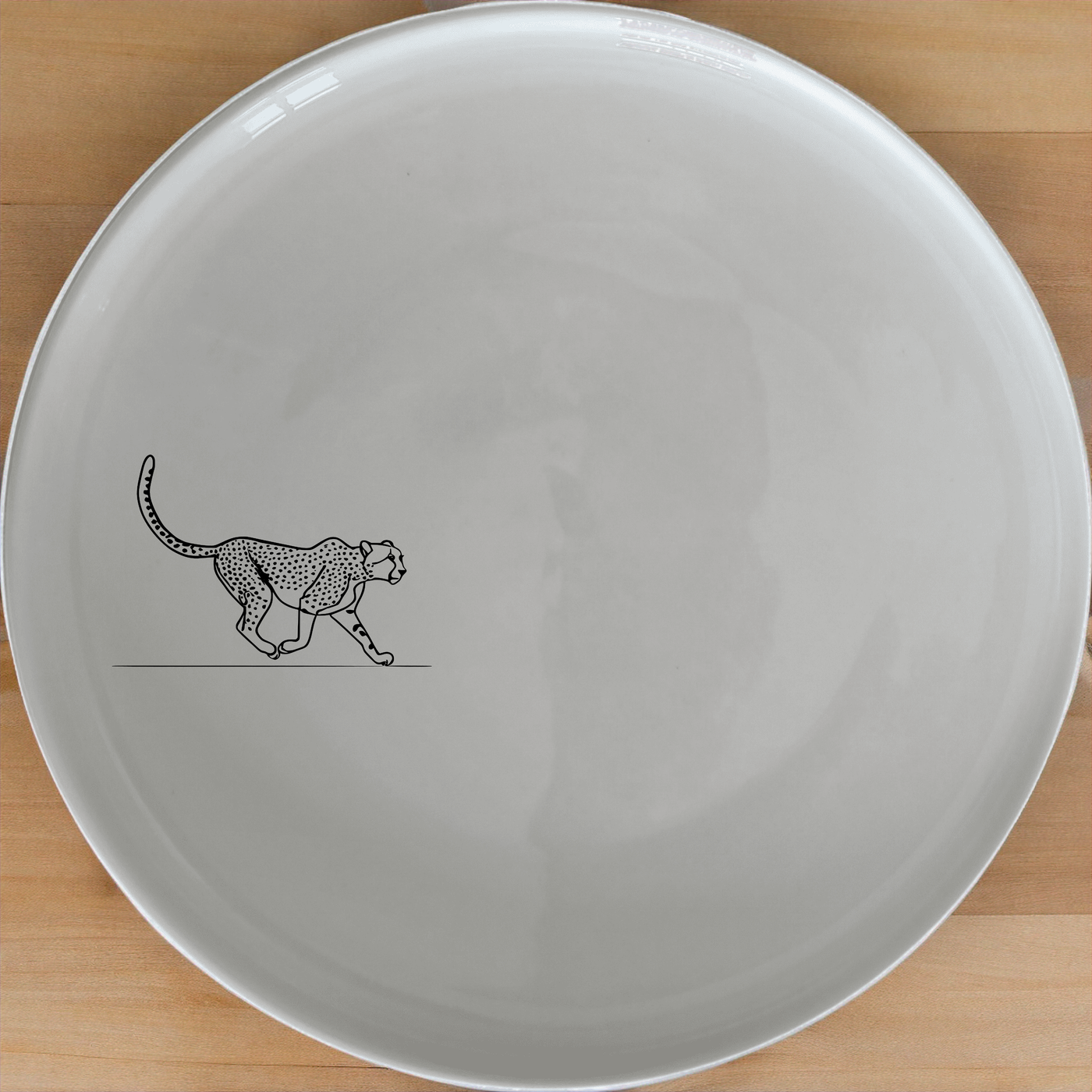 The Graceful Cheetah Dinner Plate Set of 4 - Range 3 features sleek cheetah designs on white ceramic plates, perfect for modern dining.