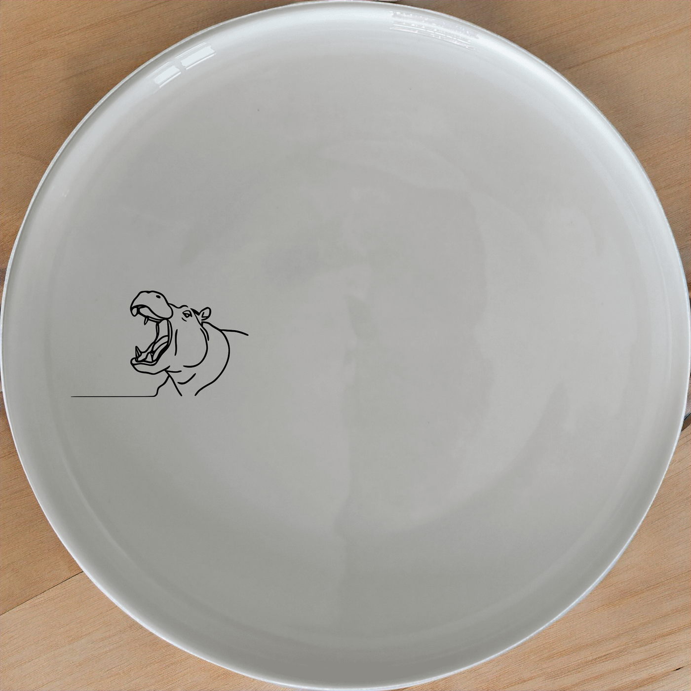 The Hippo Yawning Dinner Plate Set of 4 - Range 3 features bold, artistic designs perfect for modern dining. Crafted from durable ceramic, these plates are microwave and dishwasher safe.