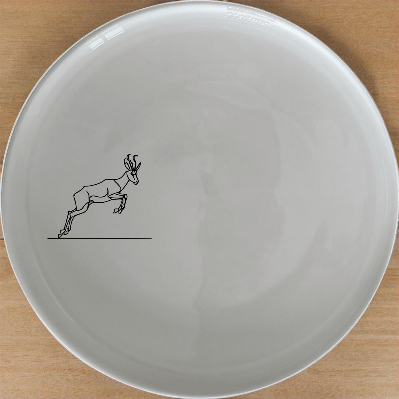 Springbok Leaping Dinner Plate Set of 4 - Range 2 features a dynamic leaping antelope design, perfect for modern dining. This set of four plates adds a touch of nature to your table setting.