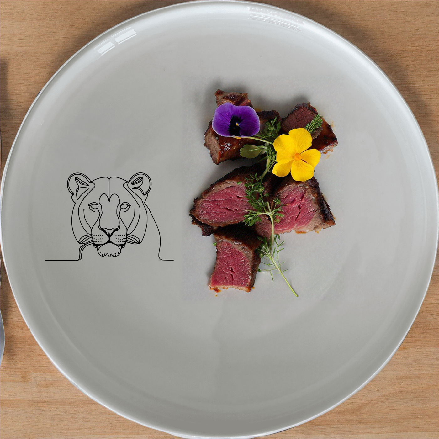 The Staring Female Lioness Dinner Set of 12 features minimalist lioness designs on white ceramic plates, bowls, and side plates for a modern and stylish dining experience.