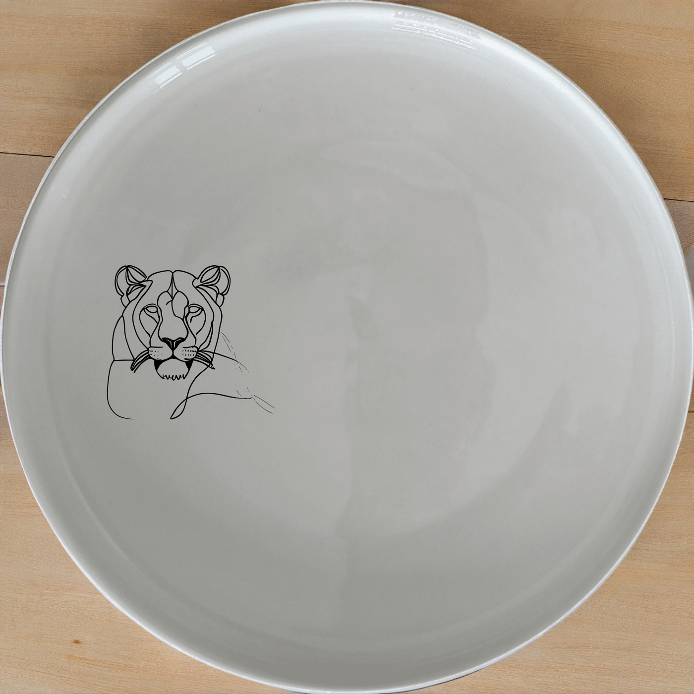 Staring Female Lioness Dinner Plate Set of 4 - Range 3 is a stunning set of four elegant dinner plates featuring a captivating lioness design.