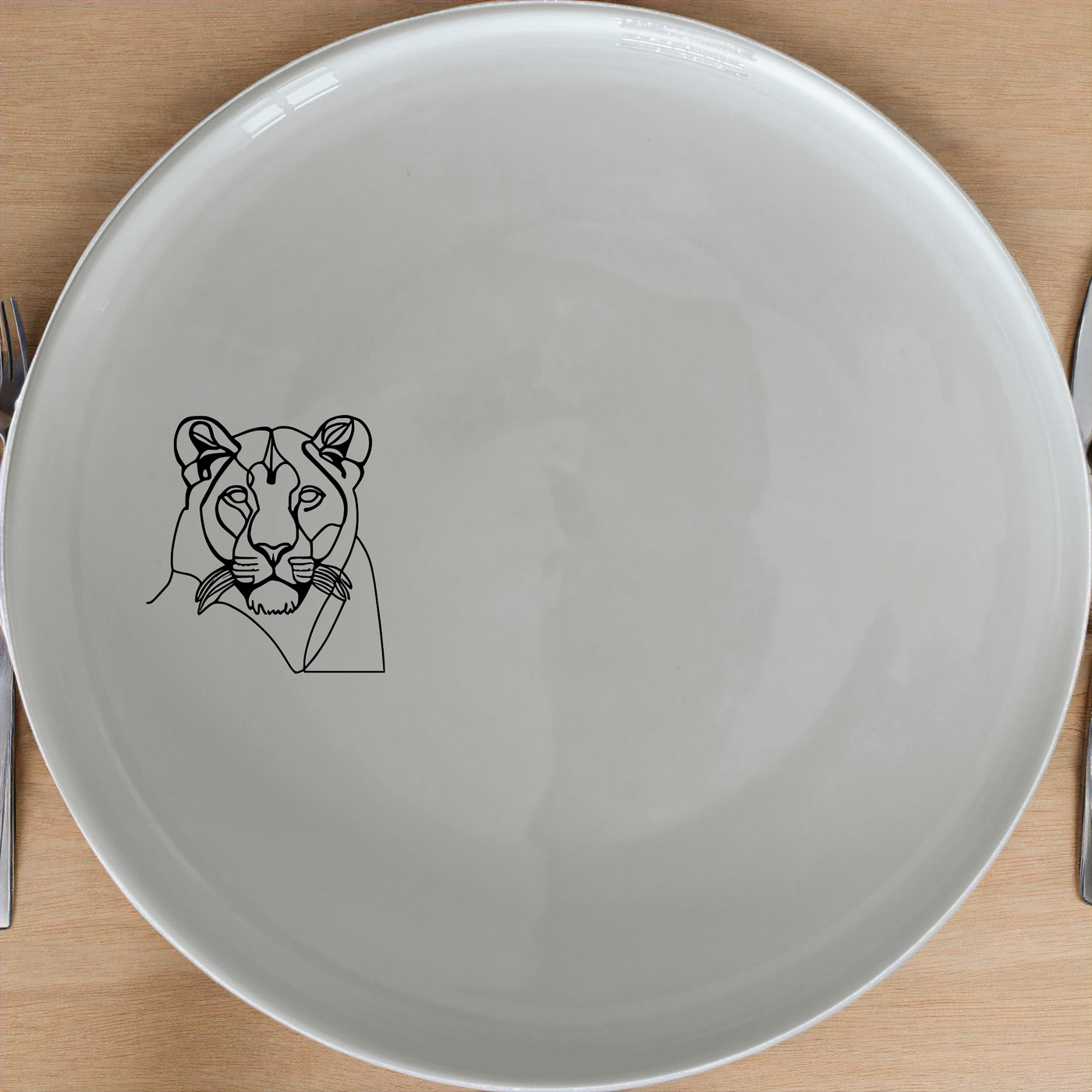 Staring Female Lioness Side Plate Set of 4 - Range 4 is a stylish and elegant addition to any dining table. This set of four side plates features a striking lioness design that adds a touch of wild elegance to your meals. Perfect for both everyday use and special occasions, these plates are made from high-quality ceramic and are dishwasher and microwave safe.